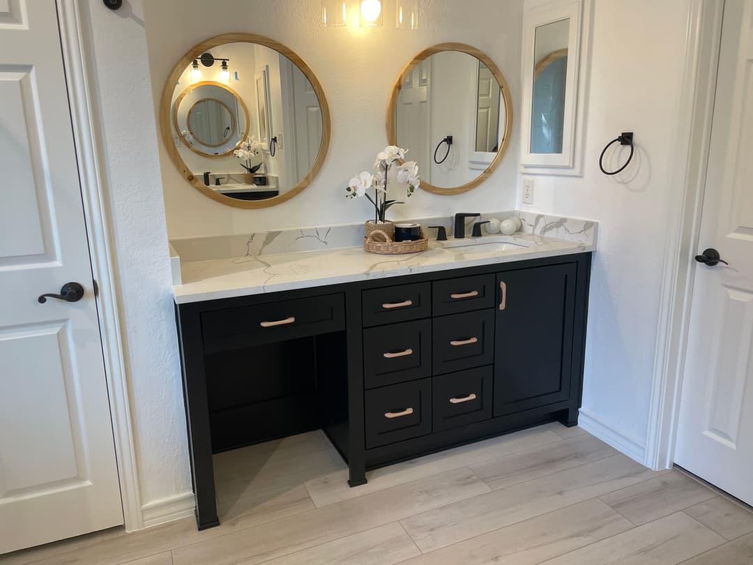 Modern bathroom vanity with dual mirrors, elegant sink, and minimalist decor.