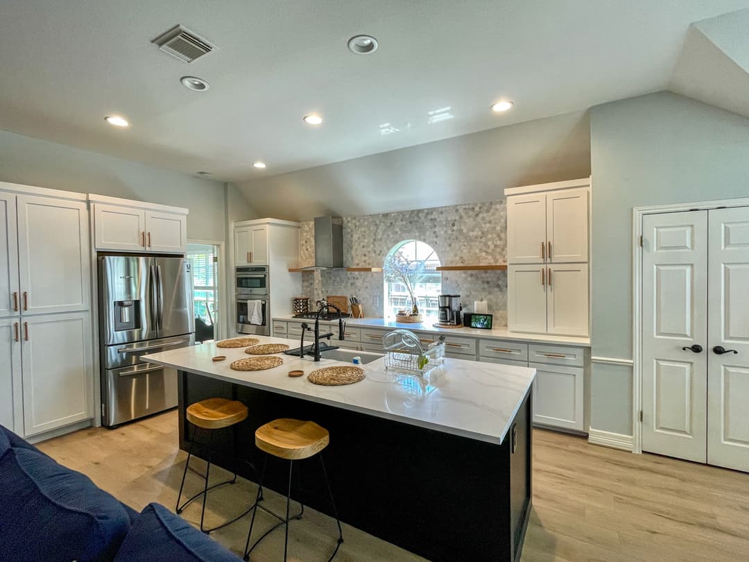 Modern kitchen featuring a central island, stainless steel appliances, and stylish decor.